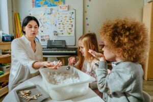 teacher teaching arts and crafts
