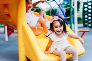 Girls going down slide in the preschool