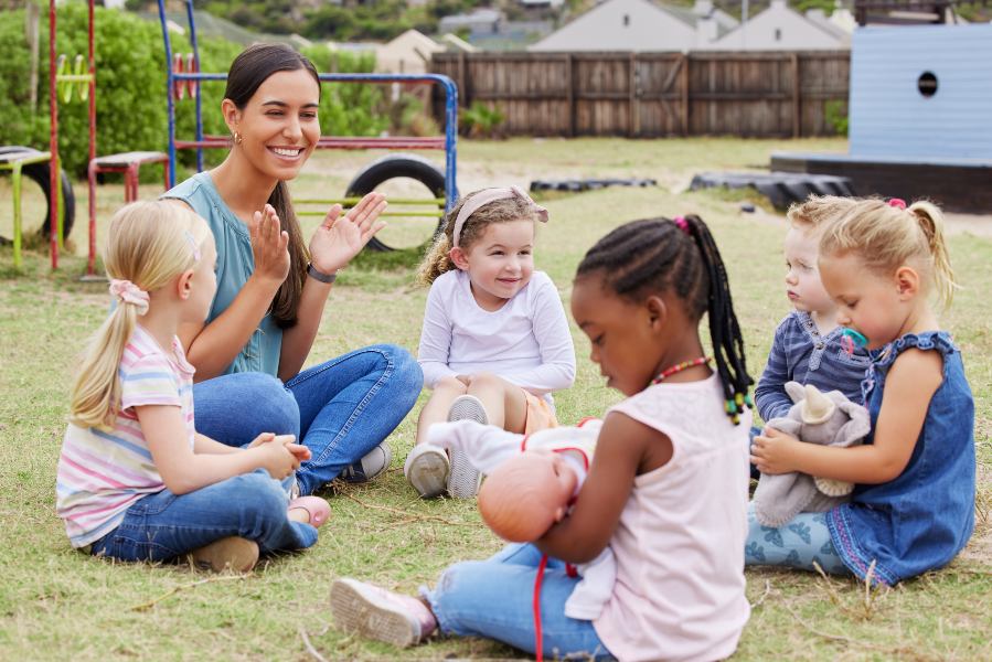 teacher singing with kids outside