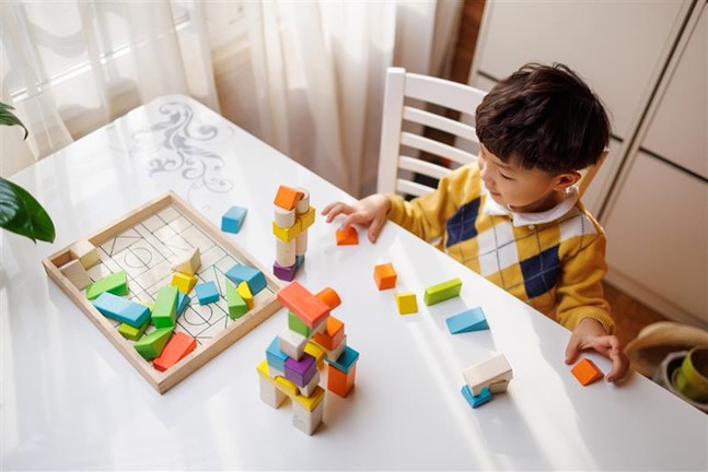 A child playing with colorful blocks