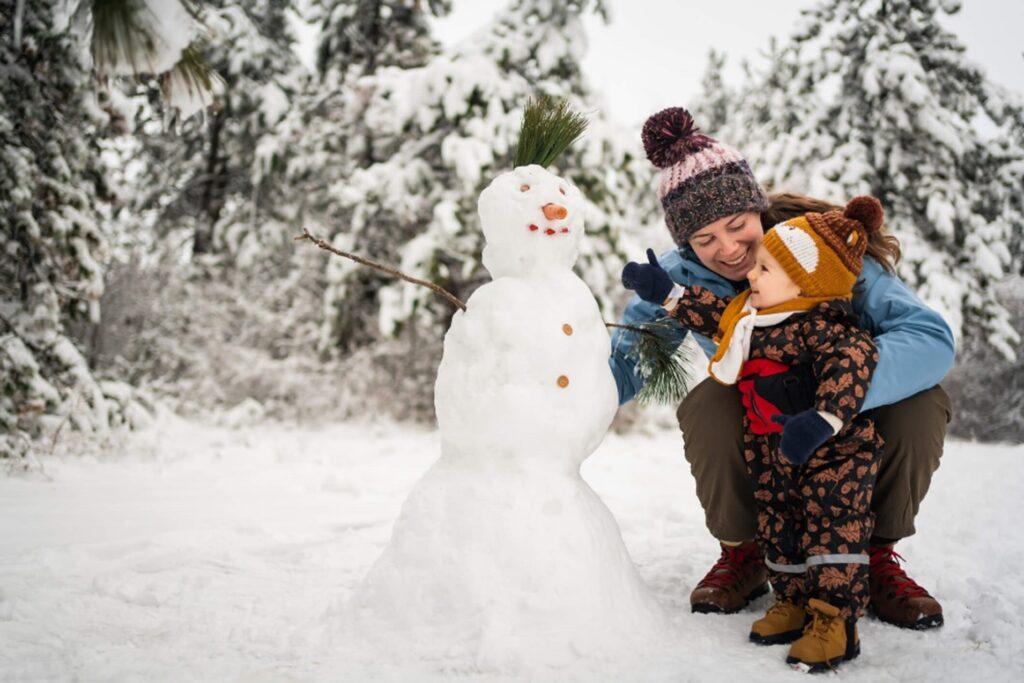 A toddler playing with snow at a child care center in Laurel, NJ.