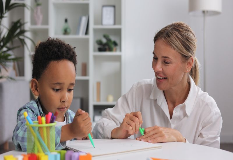 Child learning essential life skills through guided activity with teacher in Bensalem PA.