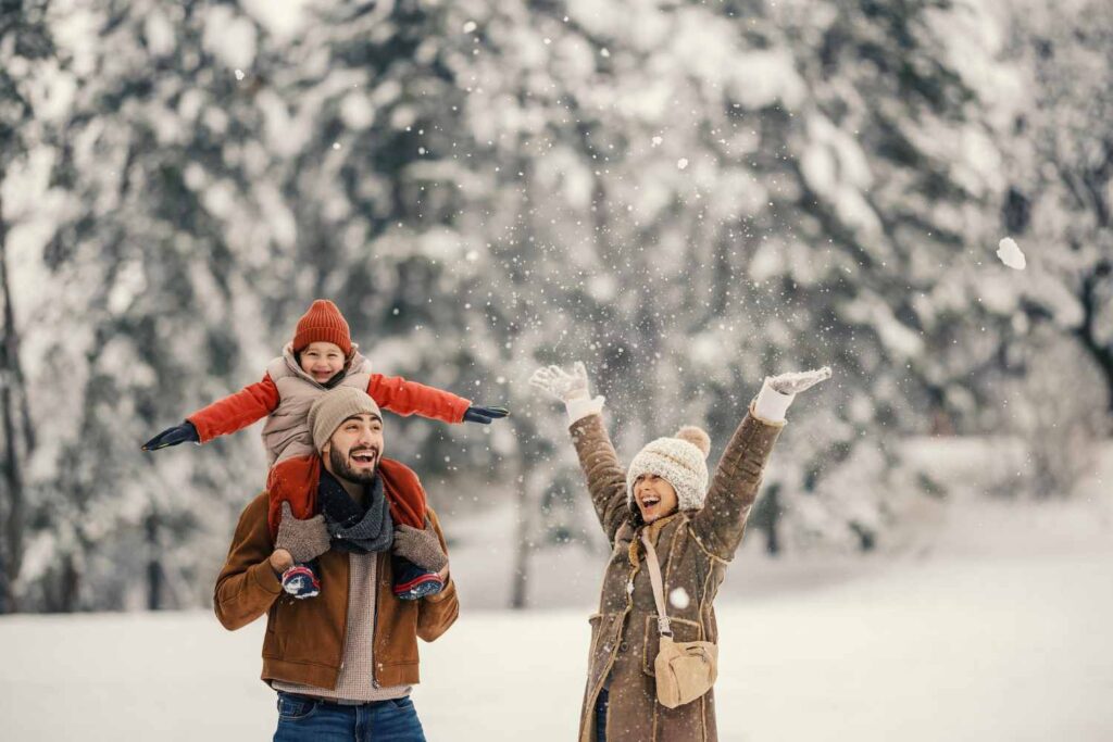 Children enjoying outdoor winter activities in a snowy setting during school winter break